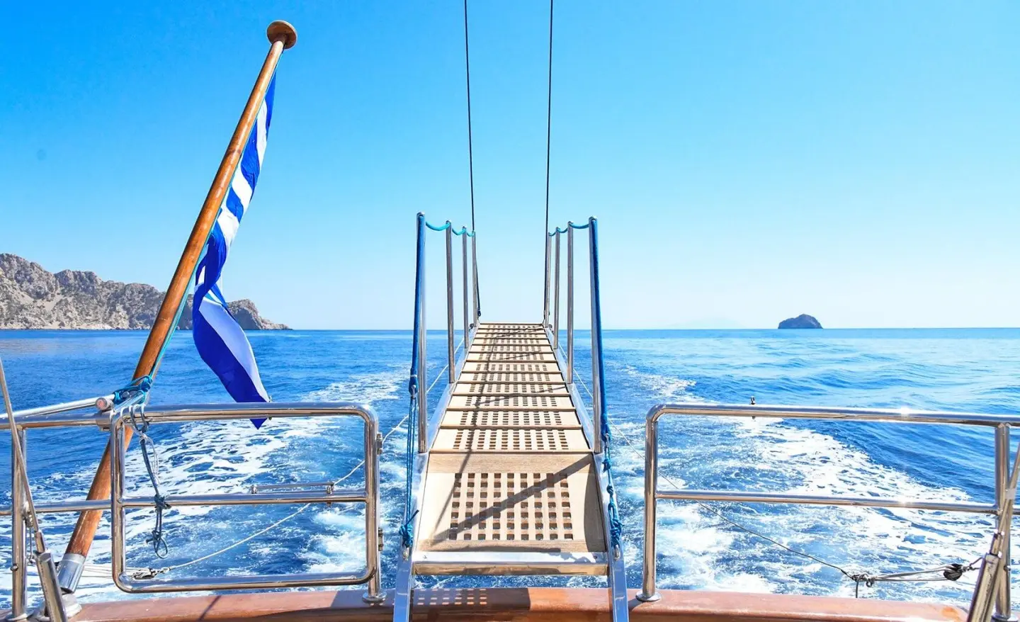 View from the yacht Tamarita deck toward open ocean, metal railing and lifelines