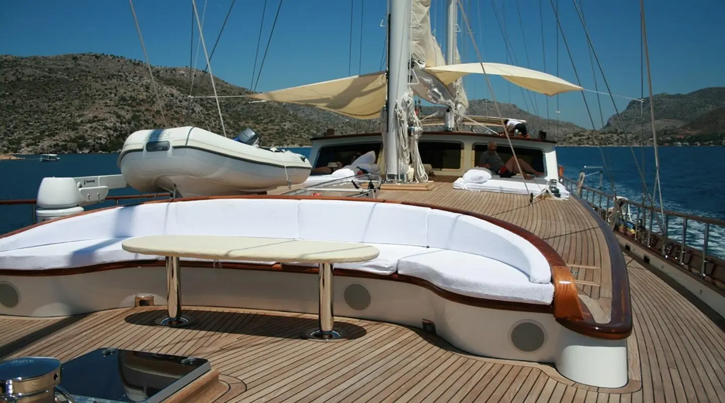 Kaya Guneri 5 yacht deck with polished wood and a white hull at sunset