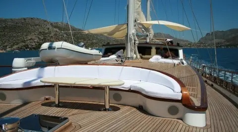 Kaya Guneri 5 yacht deck with polished wood and a white hull at sunset