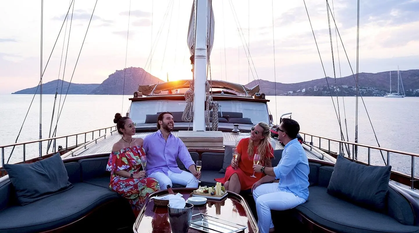 Cobra King yacht at sunset with a group dining on deck