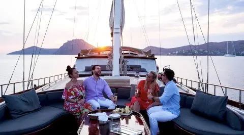 Cobra King yacht at sunset with a group dining on deck