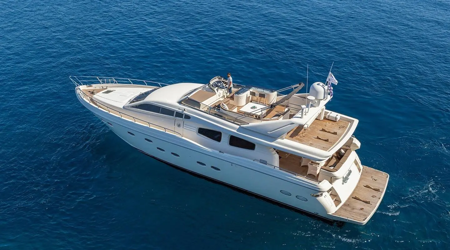 Aerial view of luxury yacht Amoraki cruising calm blue waters, white hull