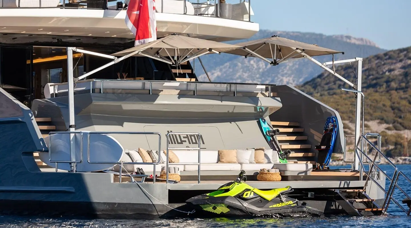 Illusion II yacht at dock with jet skis nearby and shaded deck