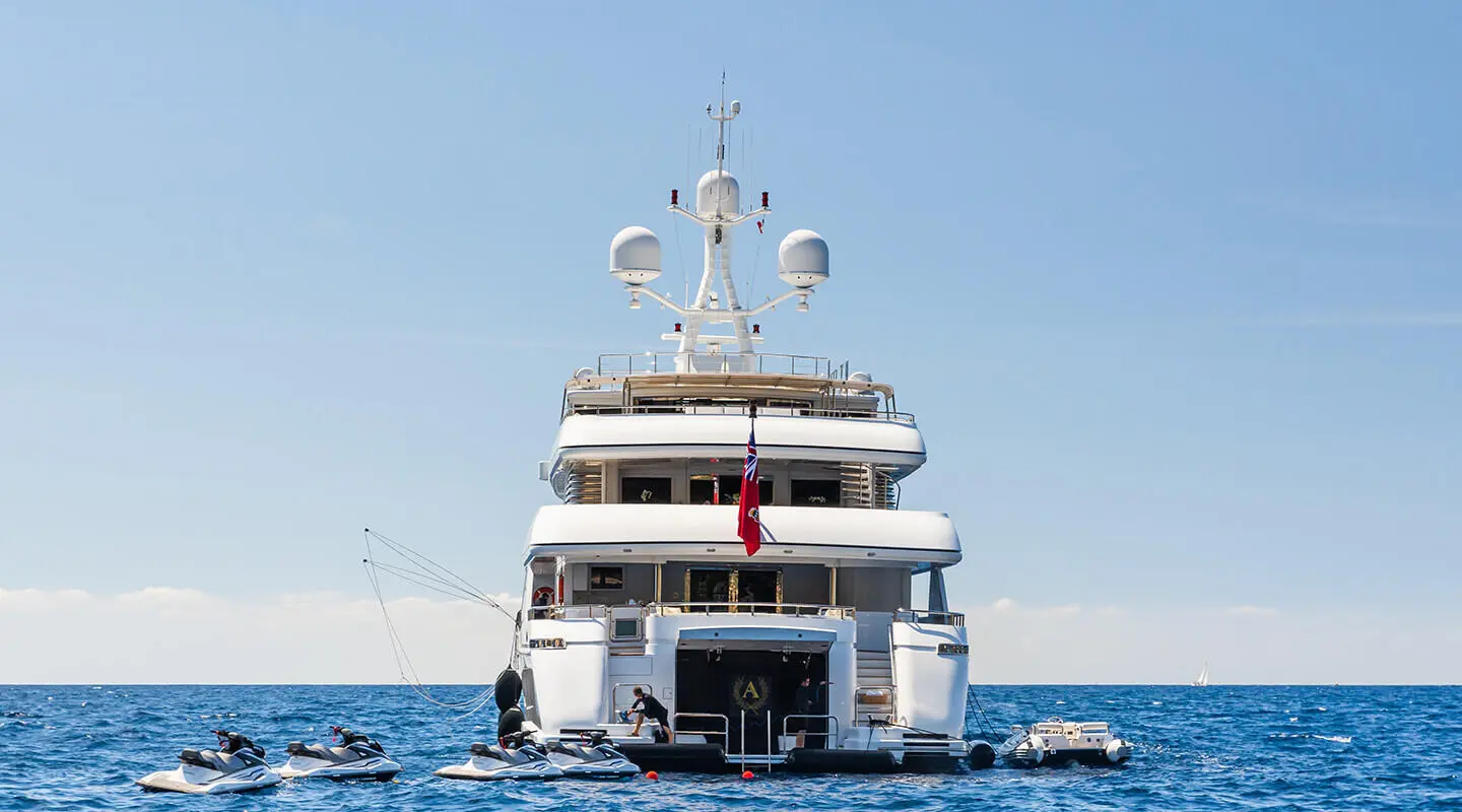 Apogee yacht on calm sea at sunset, rear view showing stern and deck