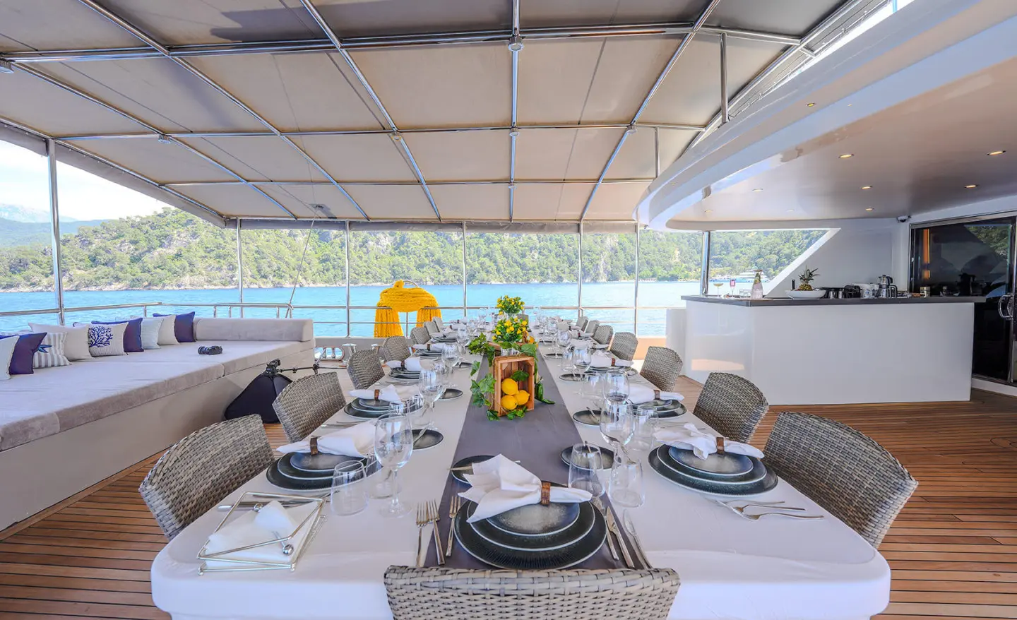 King of the Sea yacht dining setup on deck at sunset with arranged tableware