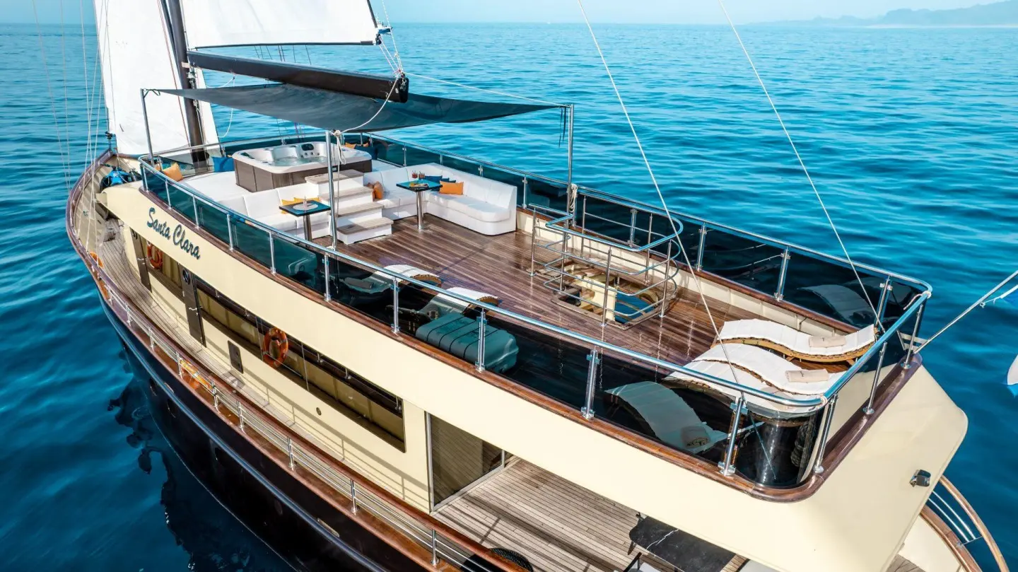 Deck view of Santa Clara luxury yacht with seating and railings over blue sea