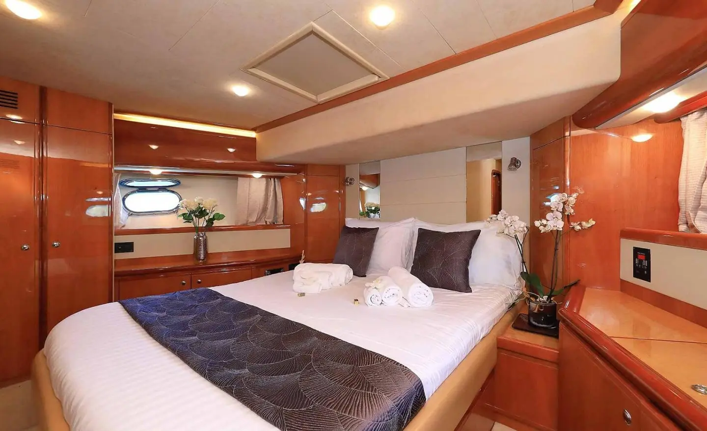 Quo Vadis I yacht cabin bedroom with two beds and warm wood tones