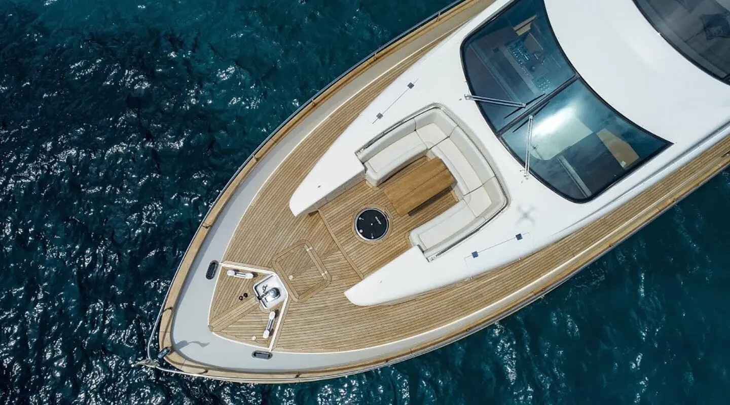 Top-down view of Salt yacht bow with teak deck and white features