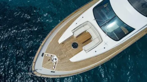 Top-down view of Salt yacht bow with teak deck and white features