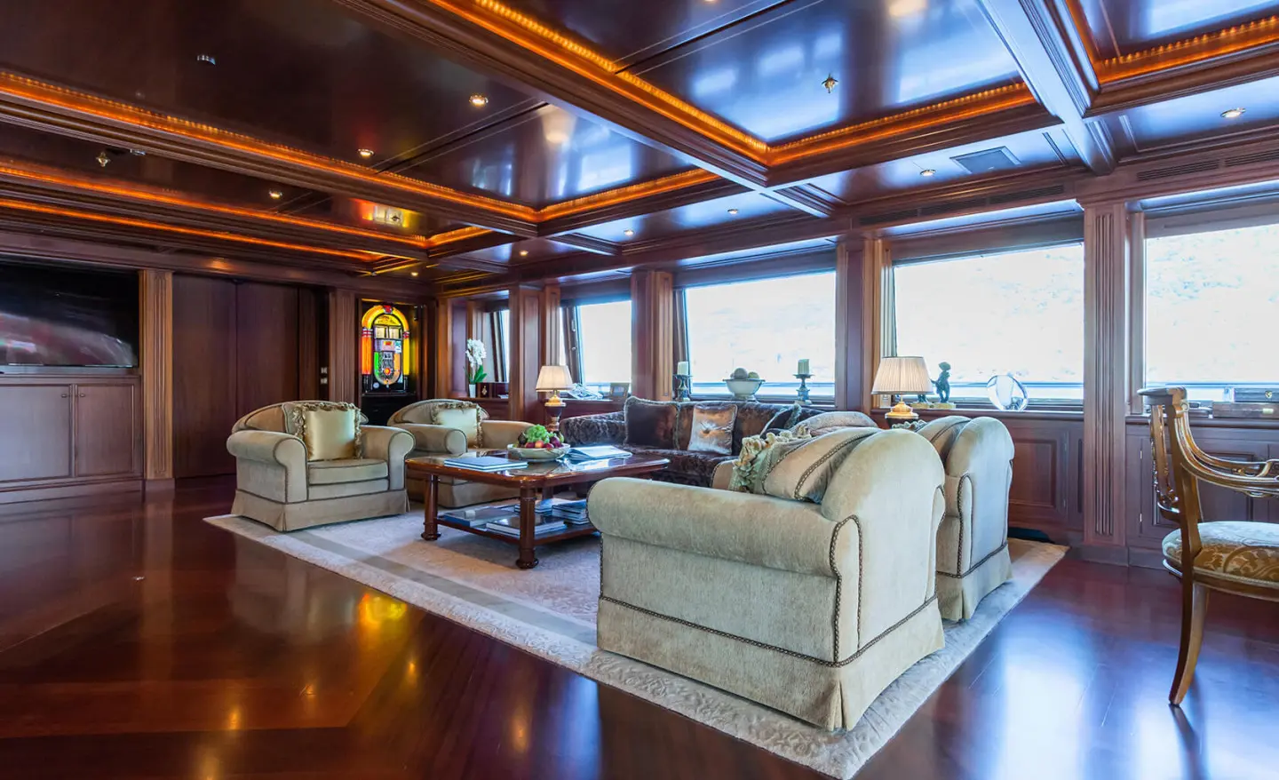 Luxurious yacht salon aboard Apogee with beige seating and polished wood
