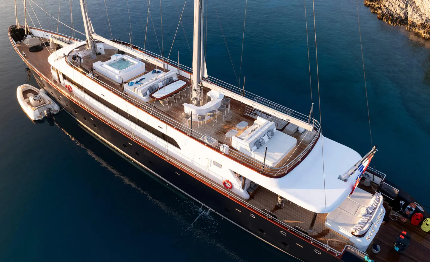 Nocturno motor yacht's sun deck with seating area above the water