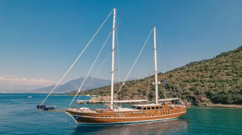 Lycian Queen luxury gulet anchored at sunset with sails lowered and calm blue sea