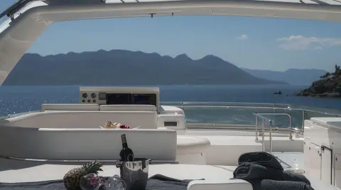 Lidia motor yacht flybridge with coastal scenery in view