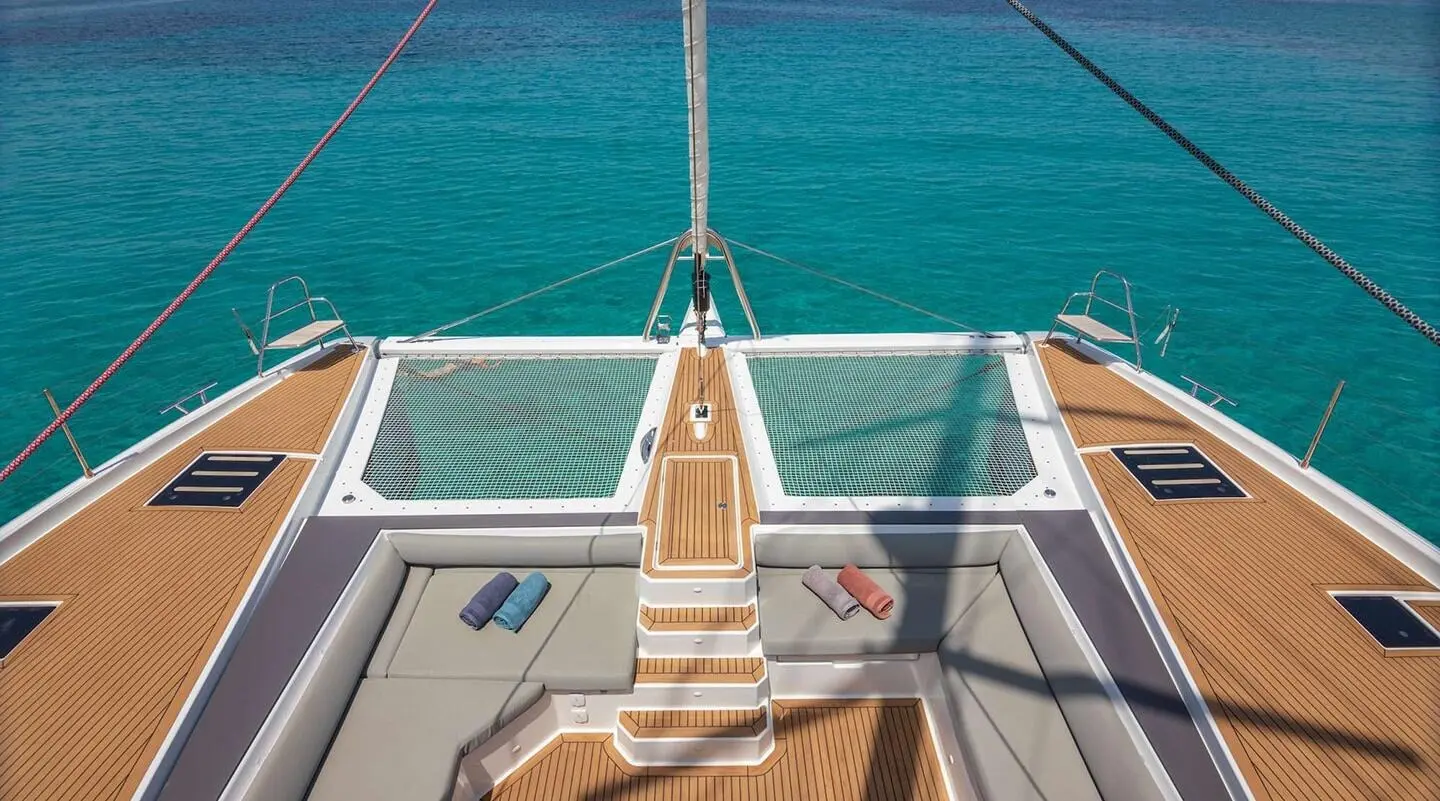 Astoria yacht sun deck with teak stairs, railing, and blue sea backdrop