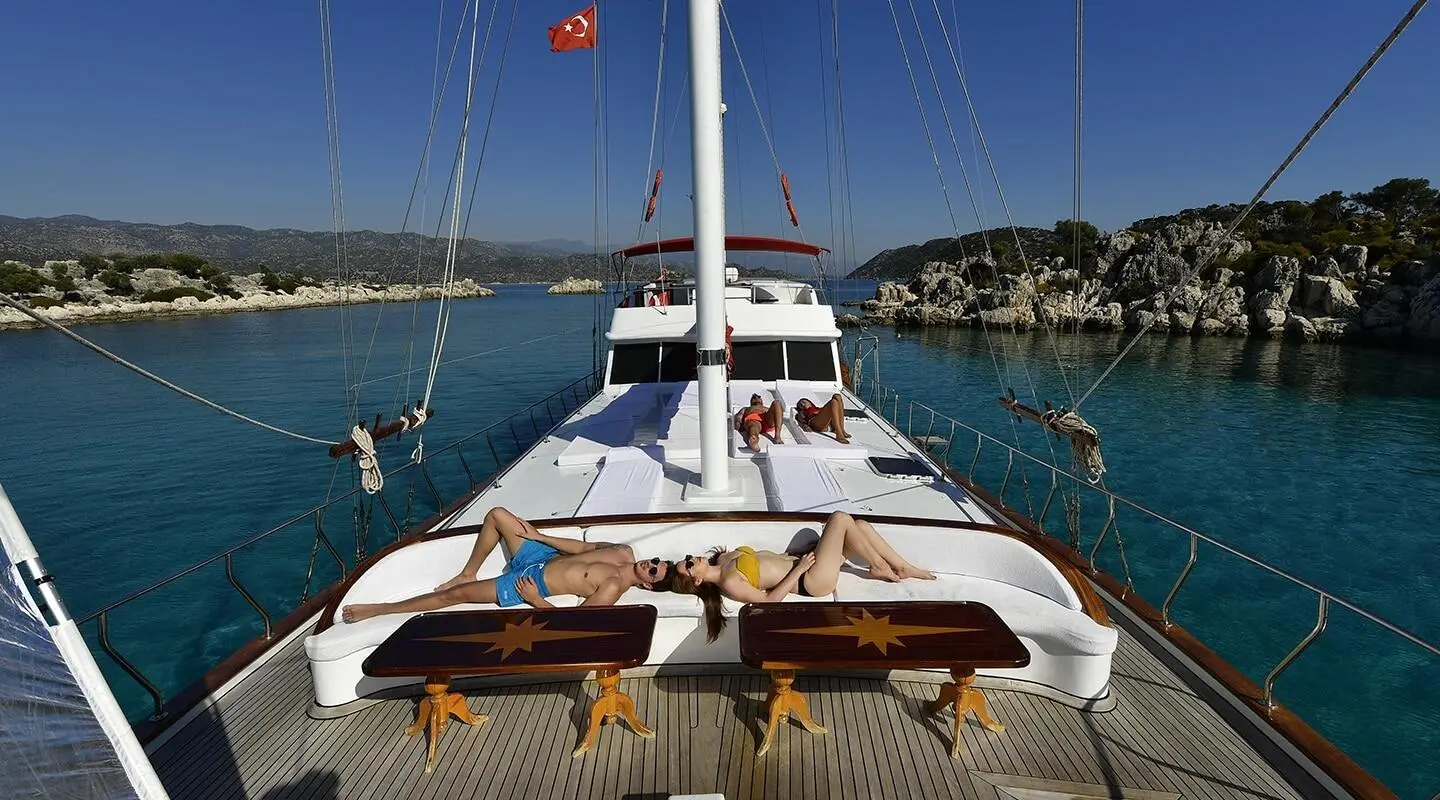 Blu Dream yacht with two sun loungers and open deck at sunset harbor