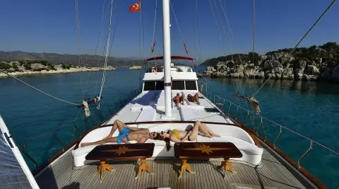 Blu Dream yacht with two sun loungers and open deck at sunset harbor