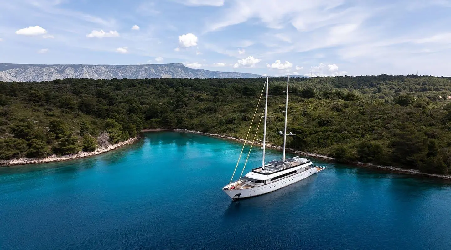 Luxury sailing yacht Anima Maris anchored in turquoise bay with clear blue water