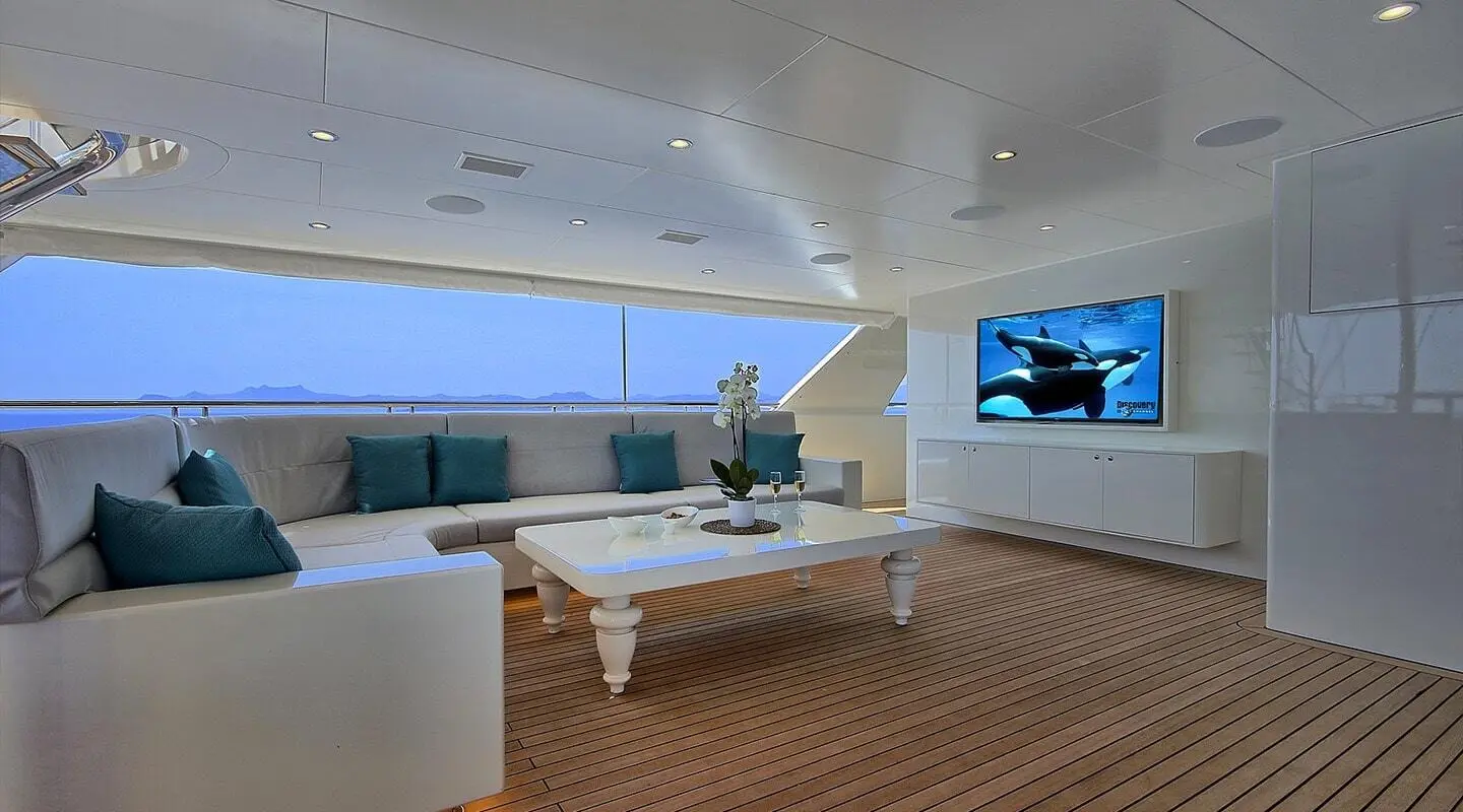 Meira yacht lounge at sunset with white seating and coffee table