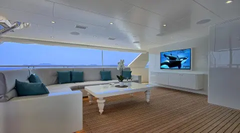 Meira yacht lounge at sunset with white seating and coffee table