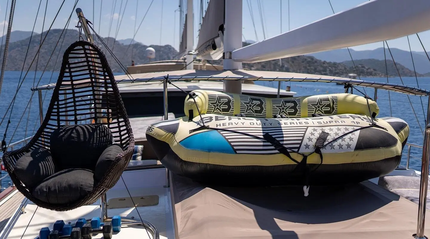 Nevra Queen luxury gulet docked at sunset with blue loungers and sails