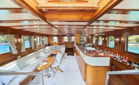 Luxurious yacht salon aboard Libra gulet with wooden interior and seating