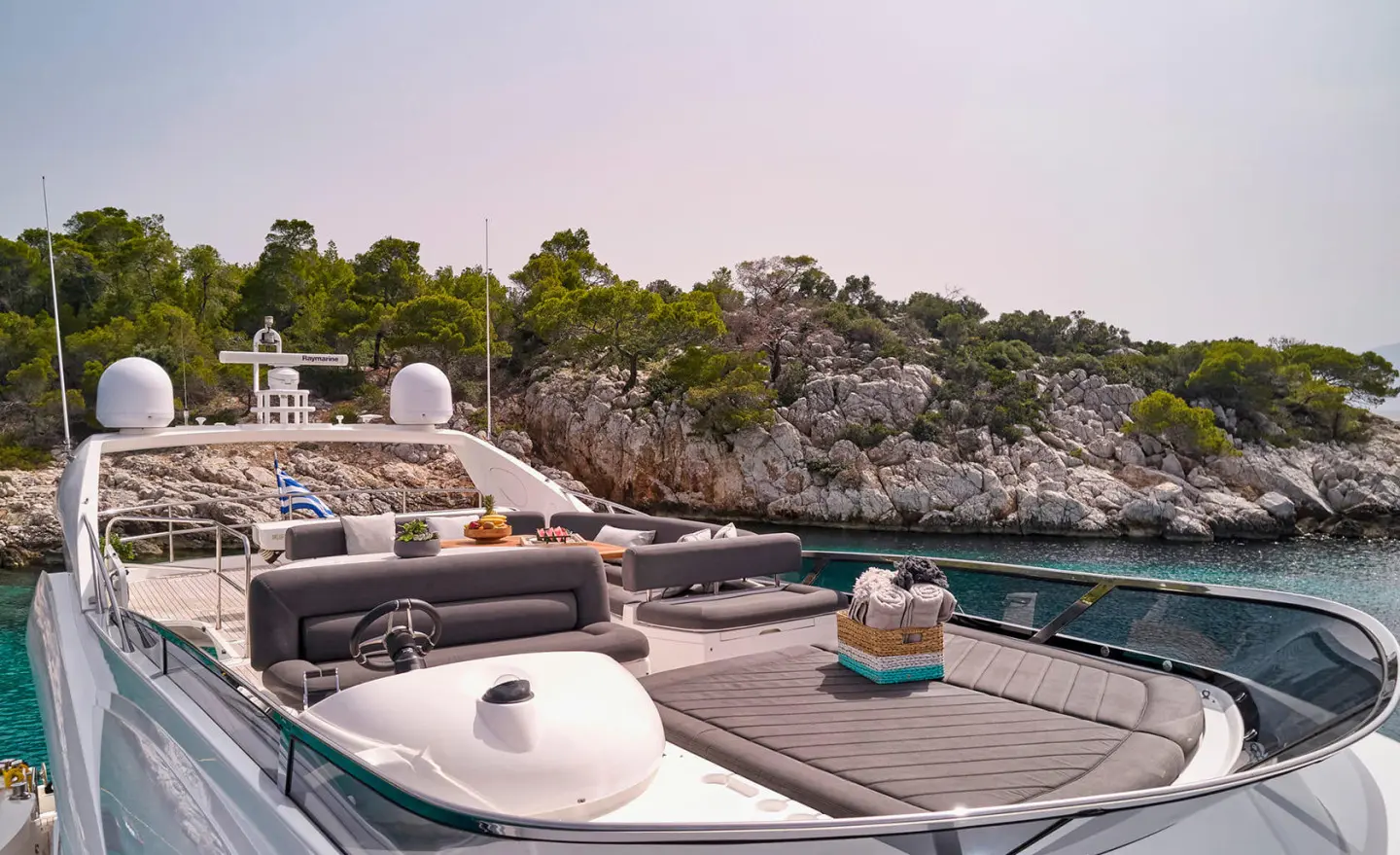 M Five motor yacht on a dock with deck seating and flybridge