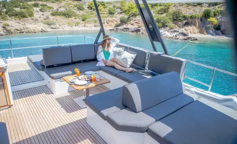Luxurious yacht D2 exterior seating area with blue cushions and table