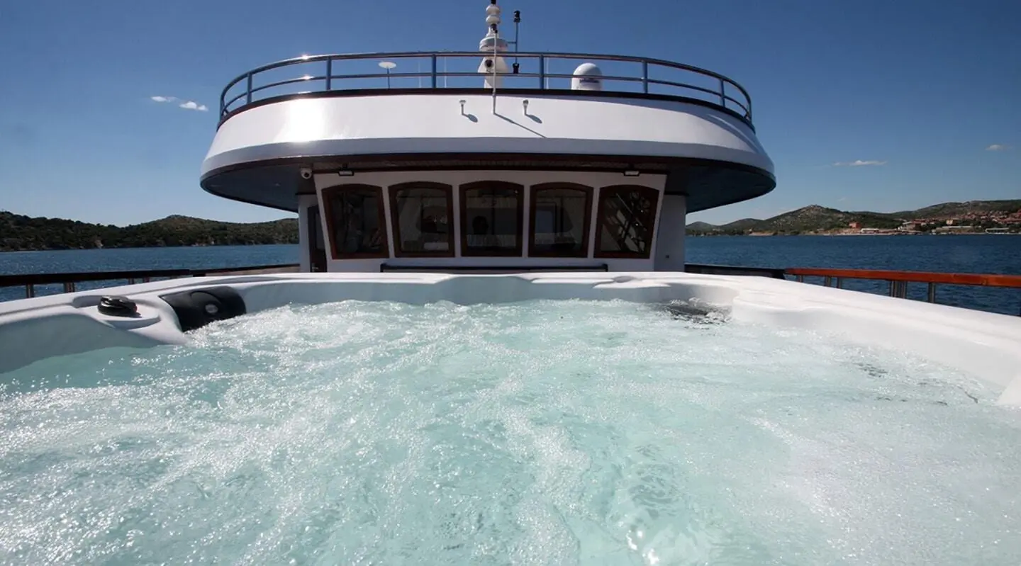 Front view of Melody luxury motor yacht cutting through turquoise water at sea