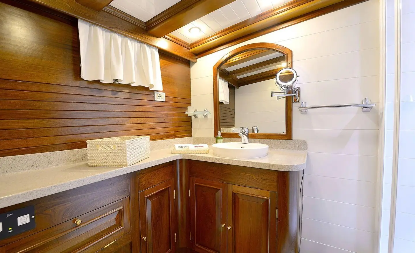Ecce Navigo gulet bathroom with sink and wooden cabinets