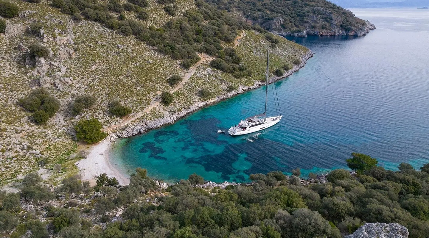 Aerial view of Long Island gulet; blue sea, coastline, yacht near shore