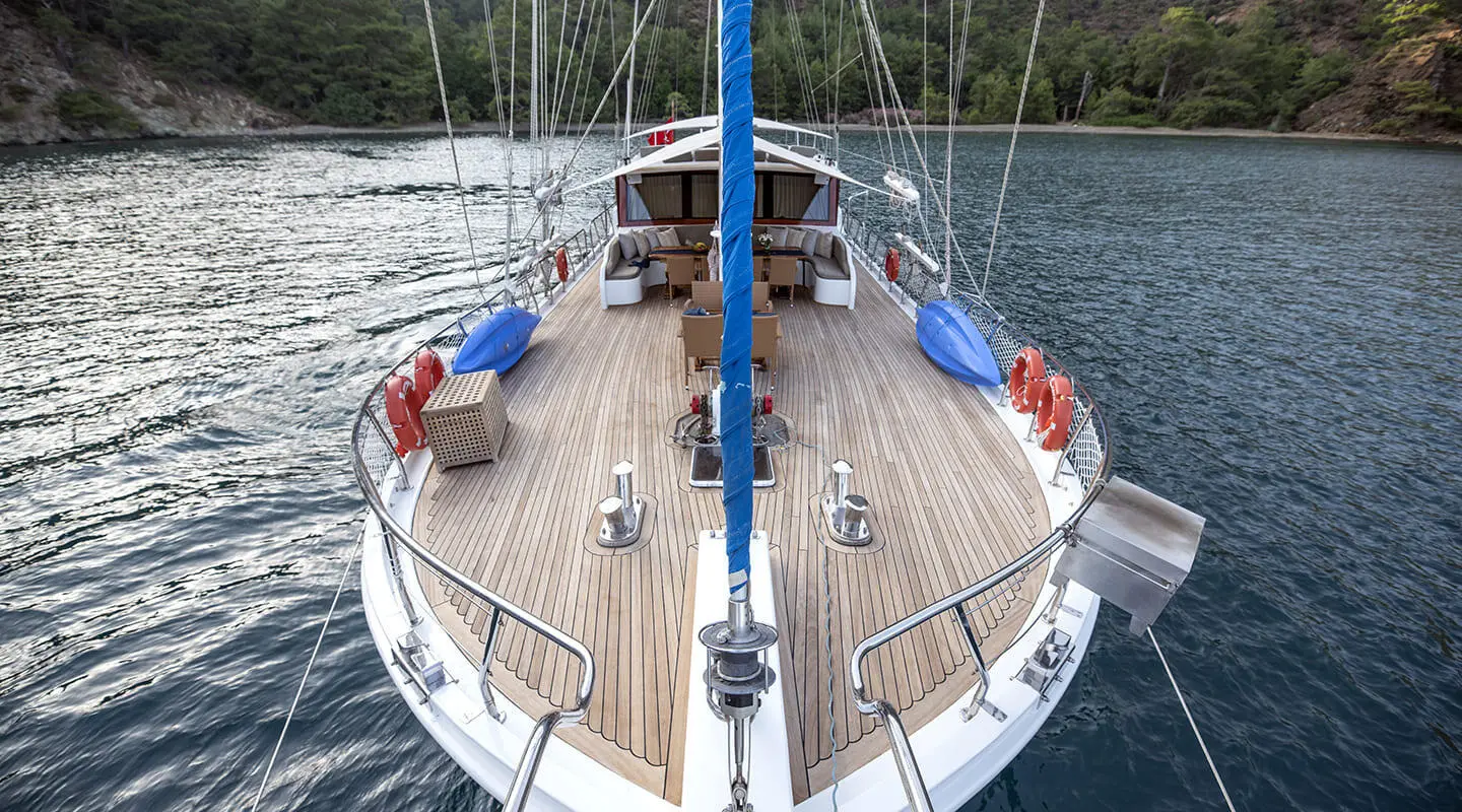 Kayhan 5 yacht moored with a teak deck and blue ropes at sunset
