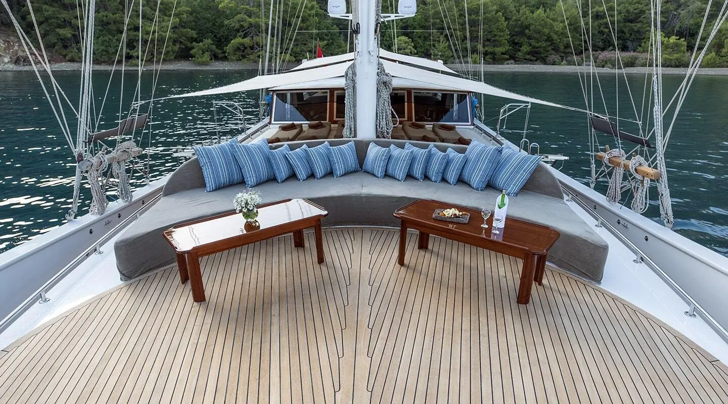 Kayhan Kaptan luxury gulet deck seating with cushions at sunset