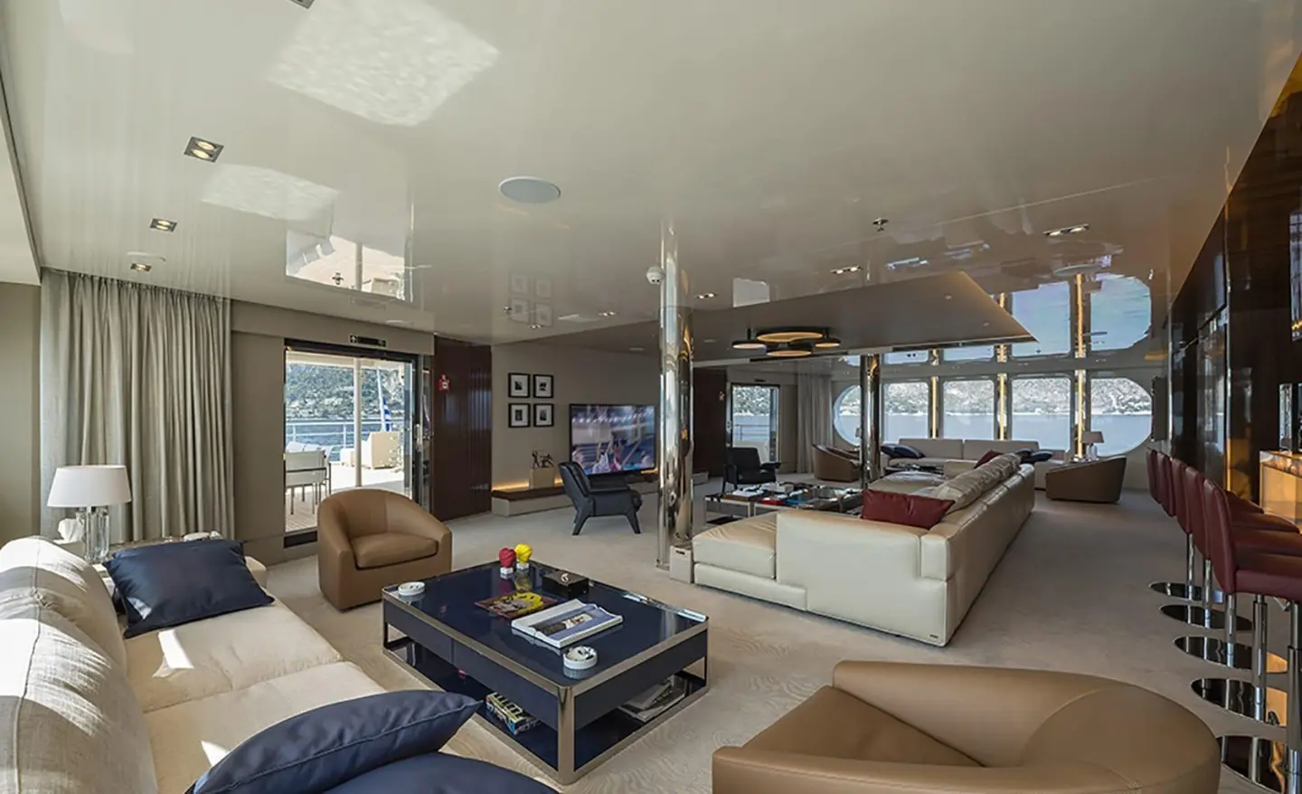 Interior of Marquise yacht: lounge area with seating, coffee table, and glass doors