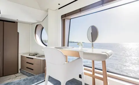 Viva II yacht exterior: white hull, large windows, deck seating near railing