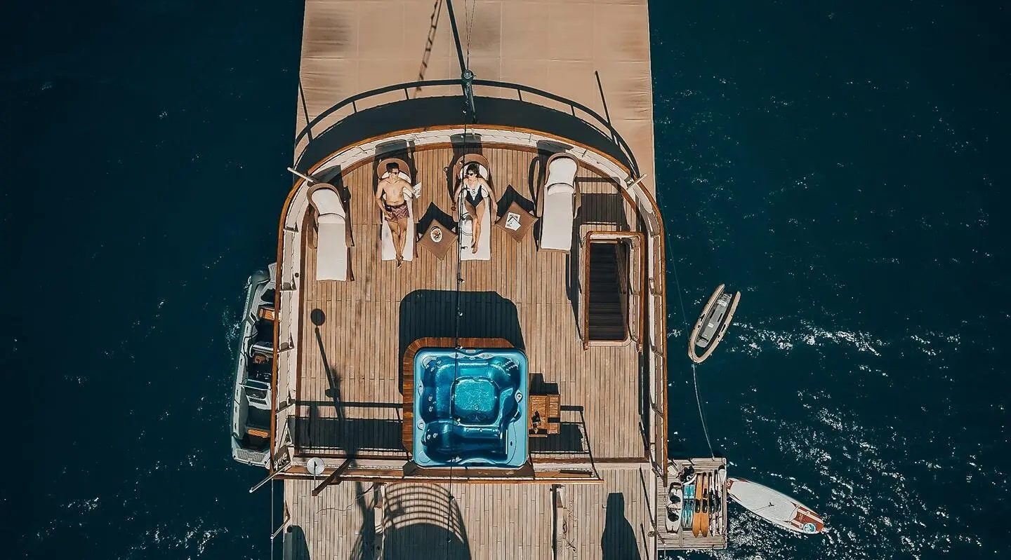 Top-down view of Seagull II yacht with blue seating on deck and surrounding water