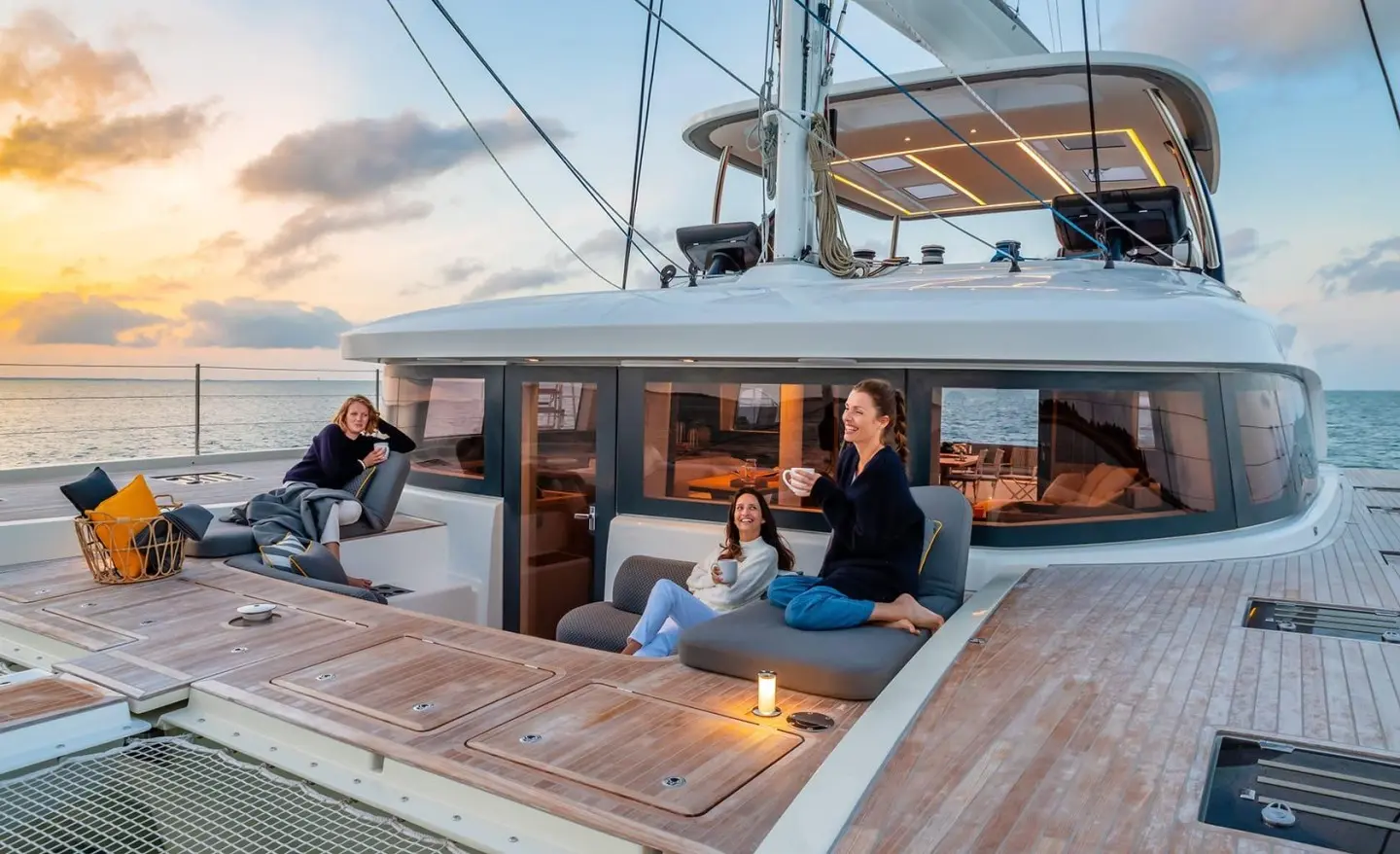 Daiquiri luxury yacht deck with people lounging on seating and sunset views