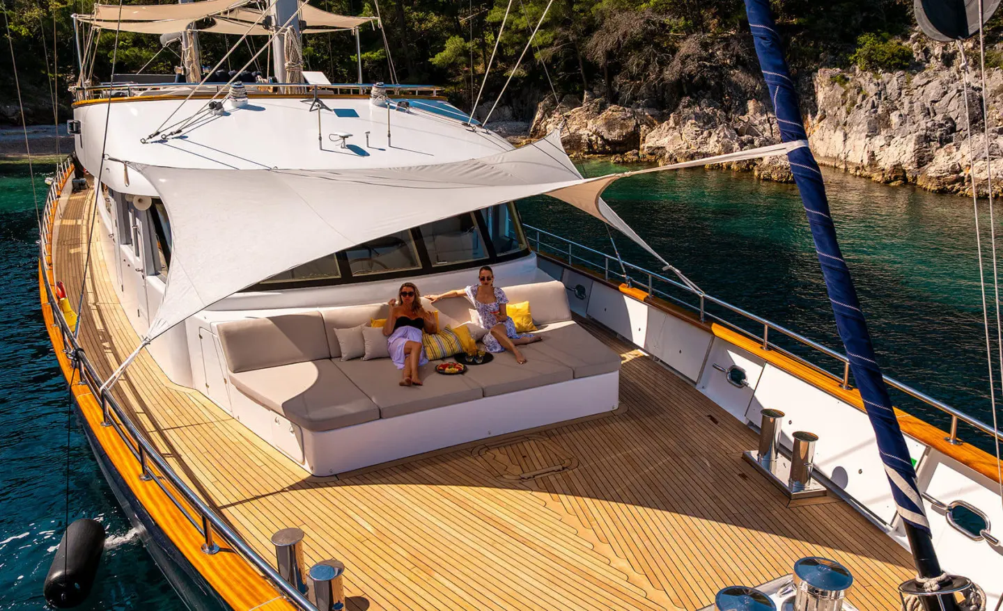 Dalmatino yacht bow deck with shaded lounge area and seating on teak wood
