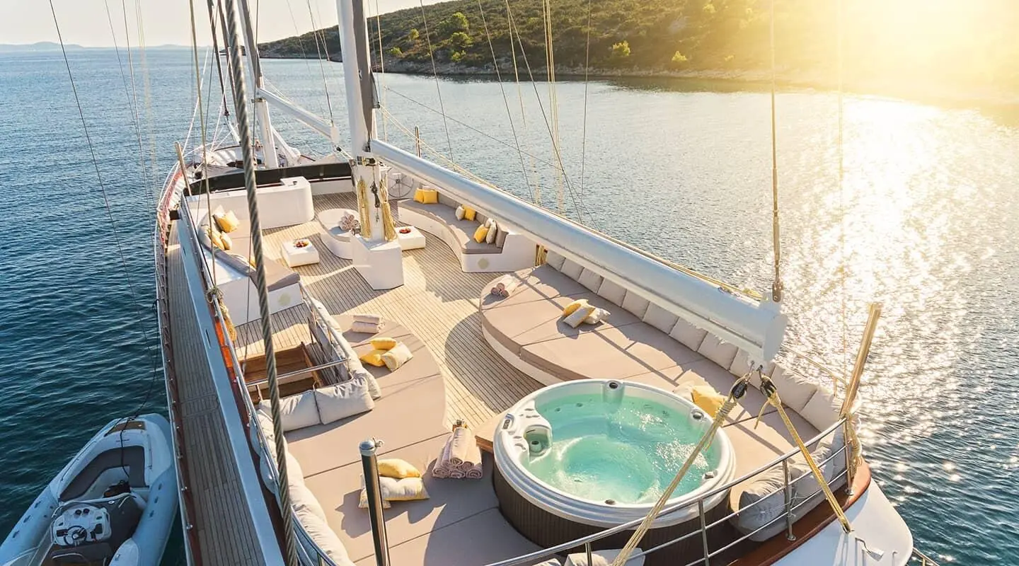 Lady Gita luxury yacht deck with sun loungers, seating, and pool on outdoor area