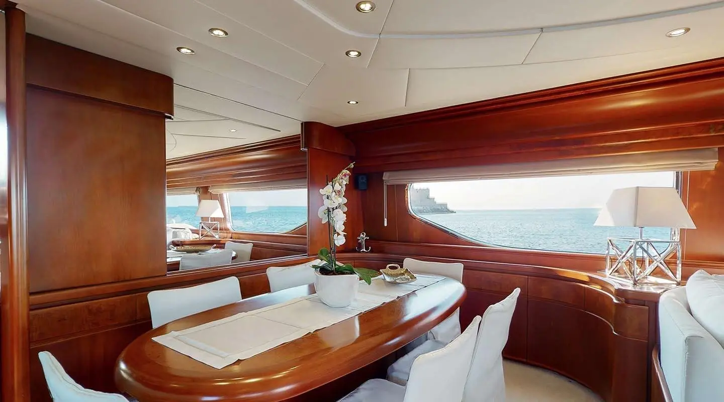 Dining area aboard Lady Natassa yacht with warm wood panels and table setting
