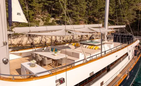 Dalmatino motor yacht deck with sun loungers and seating near railing