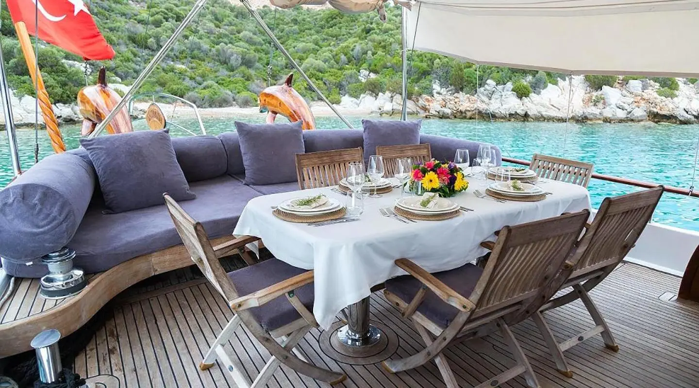 Primadonna yacht dining scene on deck with table set and beverages