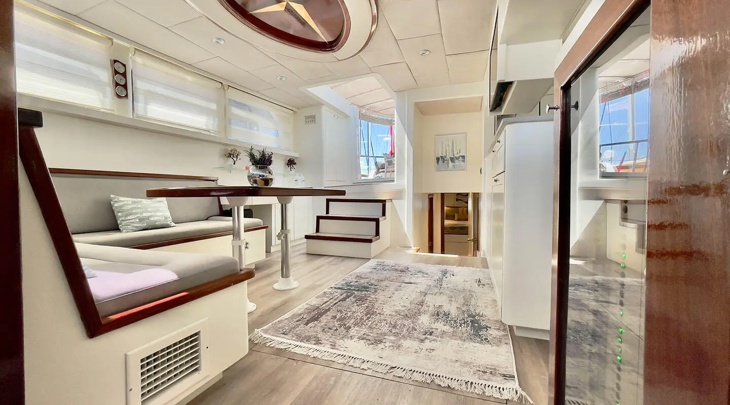 Interior of Derya Deniz gulet, comfortable seating area and tables visible