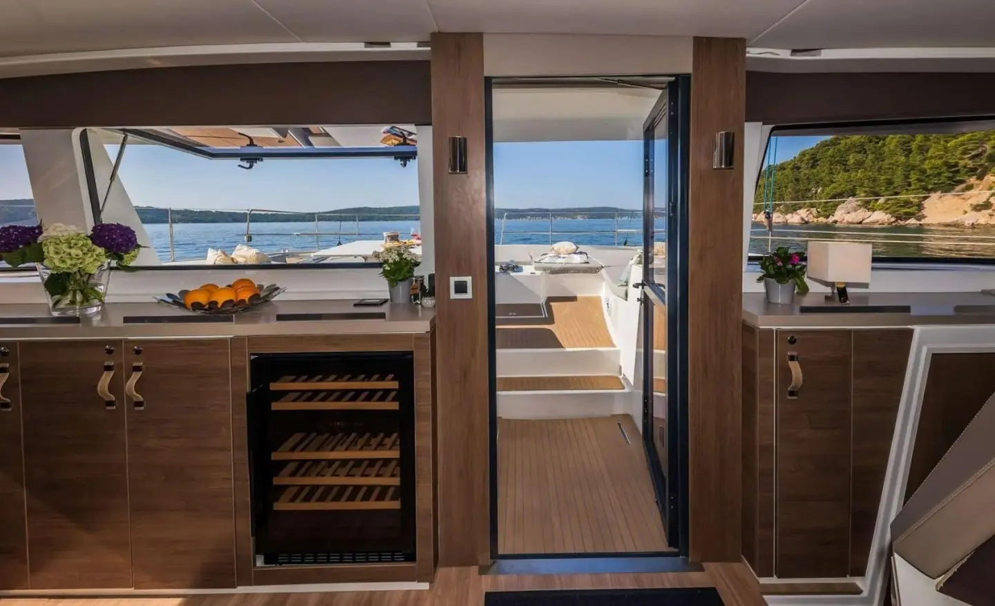 View from interior doorway to deck and ocean beyond on luxury yacht Ocean Lounge