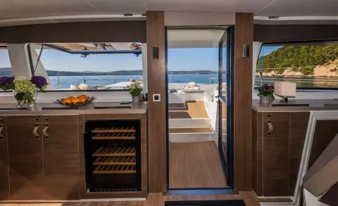 View from interior doorway to deck and ocean beyond on luxury yacht Ocean Lounge