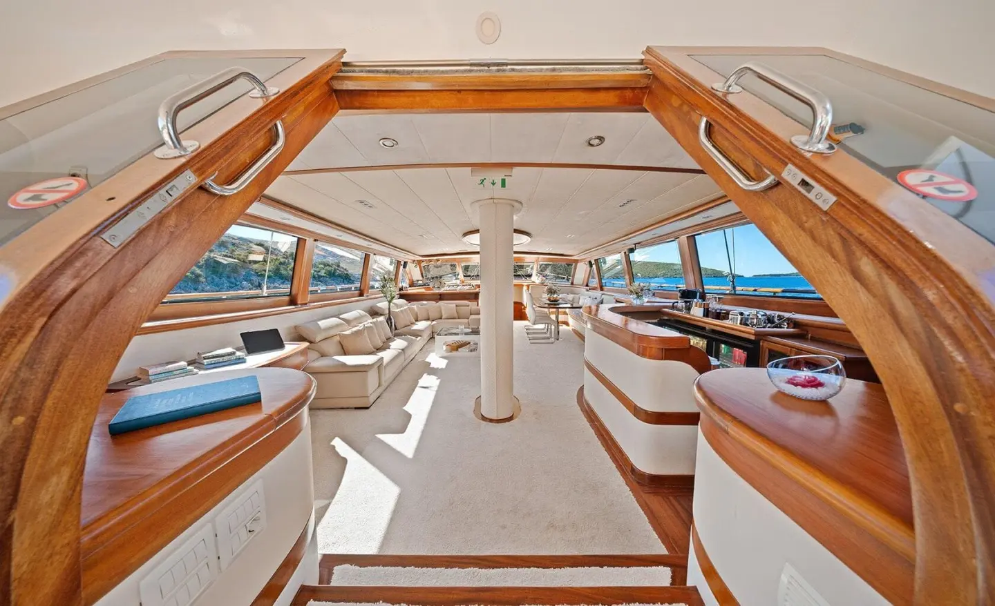 Sunset-lit yacht deck with wooden stairs and seating, Alessandro I