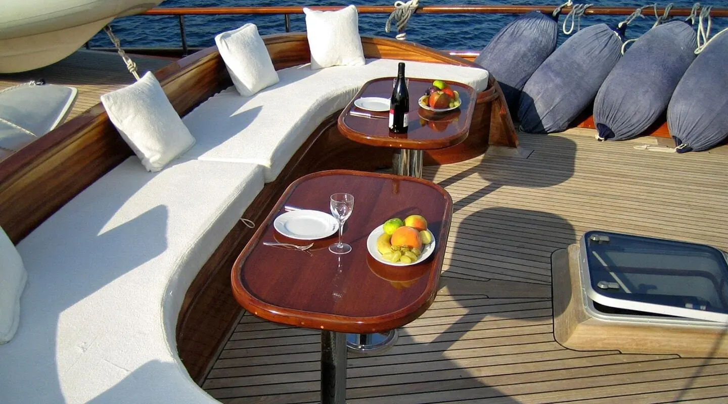 Kaya Guneri 4 yacht deck seen at sunset with lounge seating and fruit tray