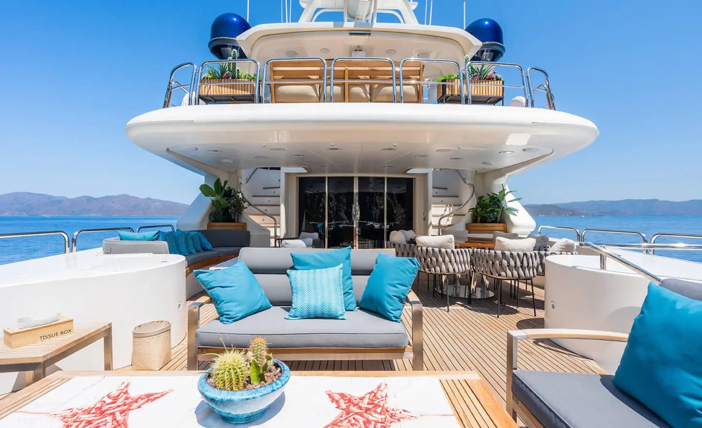 Amadea motoryacht aft deck with blue cushions and sun loungers