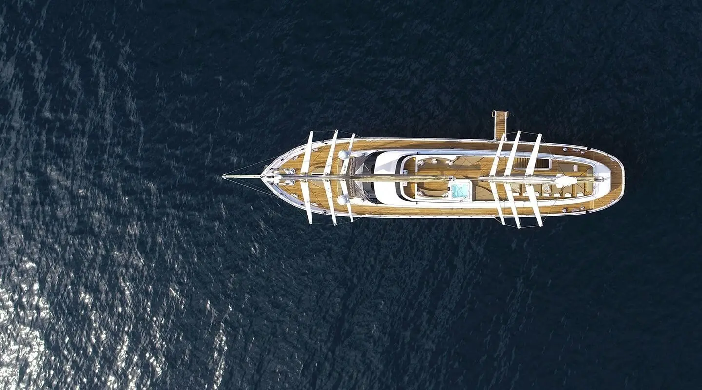 Top-down view of the Acapella luxury yacht sailing on calm deep blue water