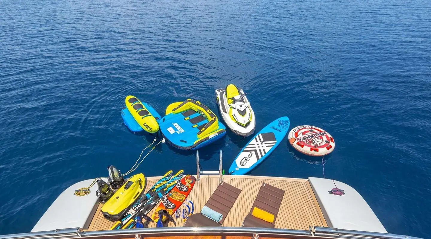 Top-down view of Grace yacht deck with colorful kayaks on water