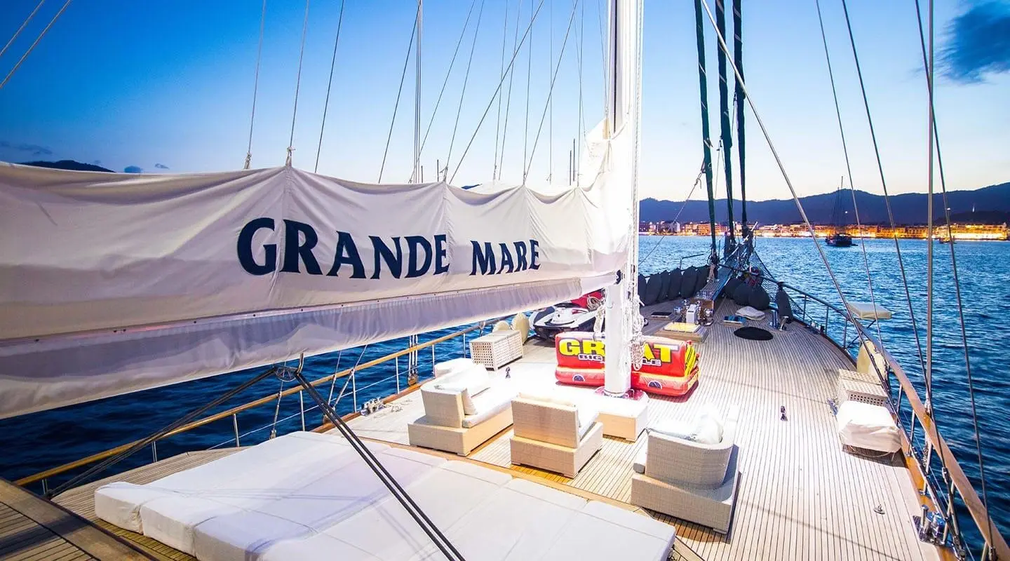 Grande Mare yacht deck with seating area and calm sea at sunset